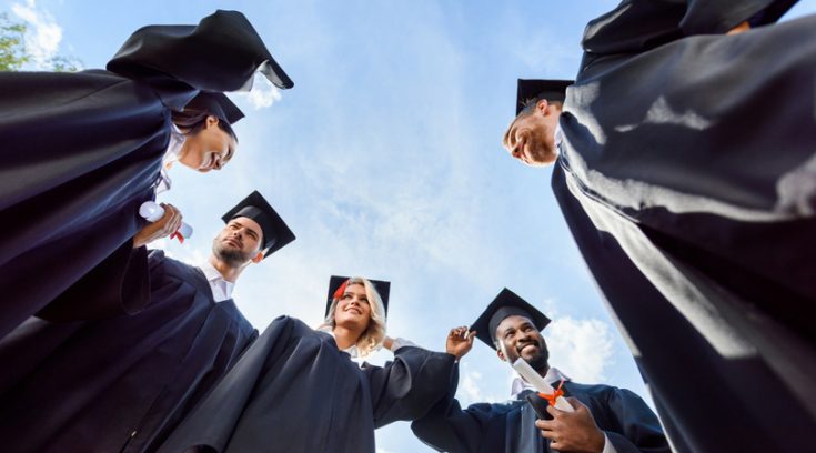 image of recent graduates standing in a circle