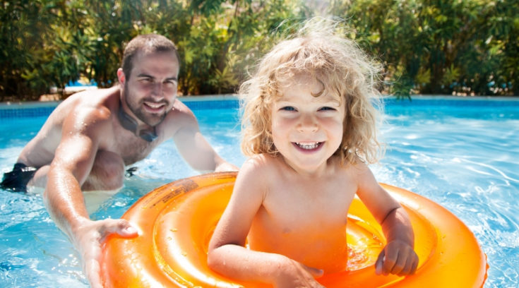 many playing in pool with child - Searching for the best travel insurance companies? Compare our favorite international medical, trip insurance, and travelers insurance programs here!