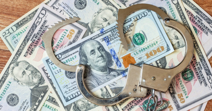 Wealthfront Review - photo of unlocked handcuffs on top of cash