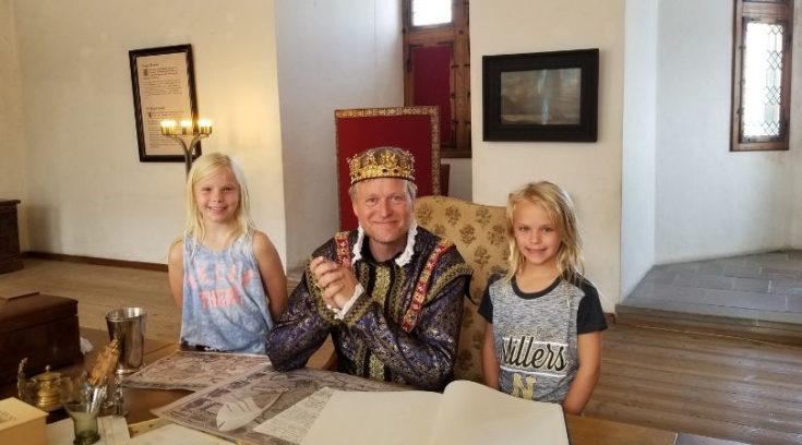 Photo of actor playing a king and two girls