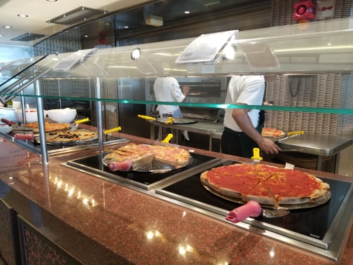 photo of pizzas on buffet