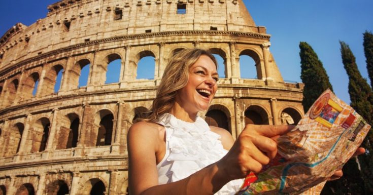 ETIAS Review_woman laughing at map in front of Colosseum