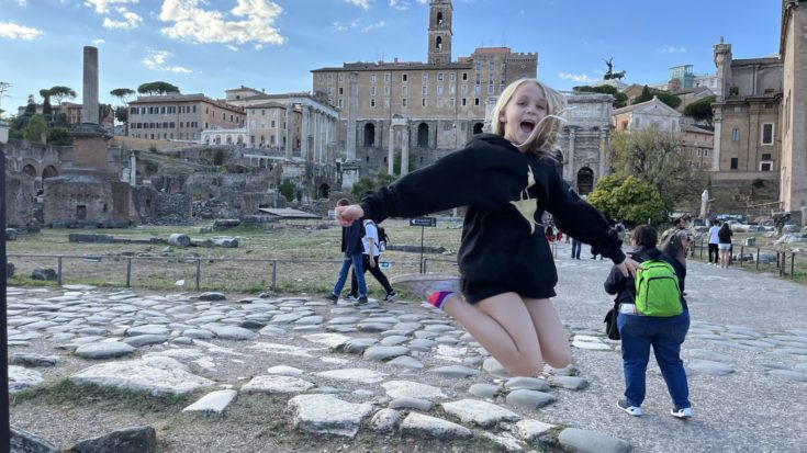 Our daughter jumping in the air inside the Roman Forum
