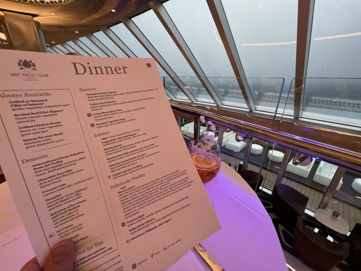Image of menu and view from Yacht Club Dining room  - MSC Seashore